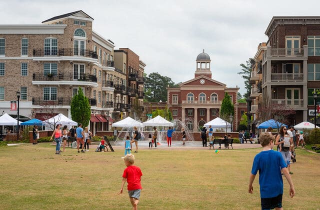 Visitors playing on open lawn in Downtown Alpharetta