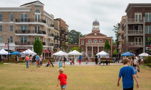 Visitors playing on open lawn in Downtown Alpharetta